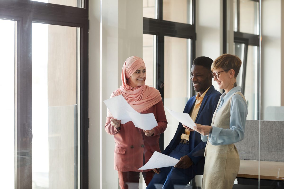 Young Multi-Ethnic Business Team Laughing in Office Lobby