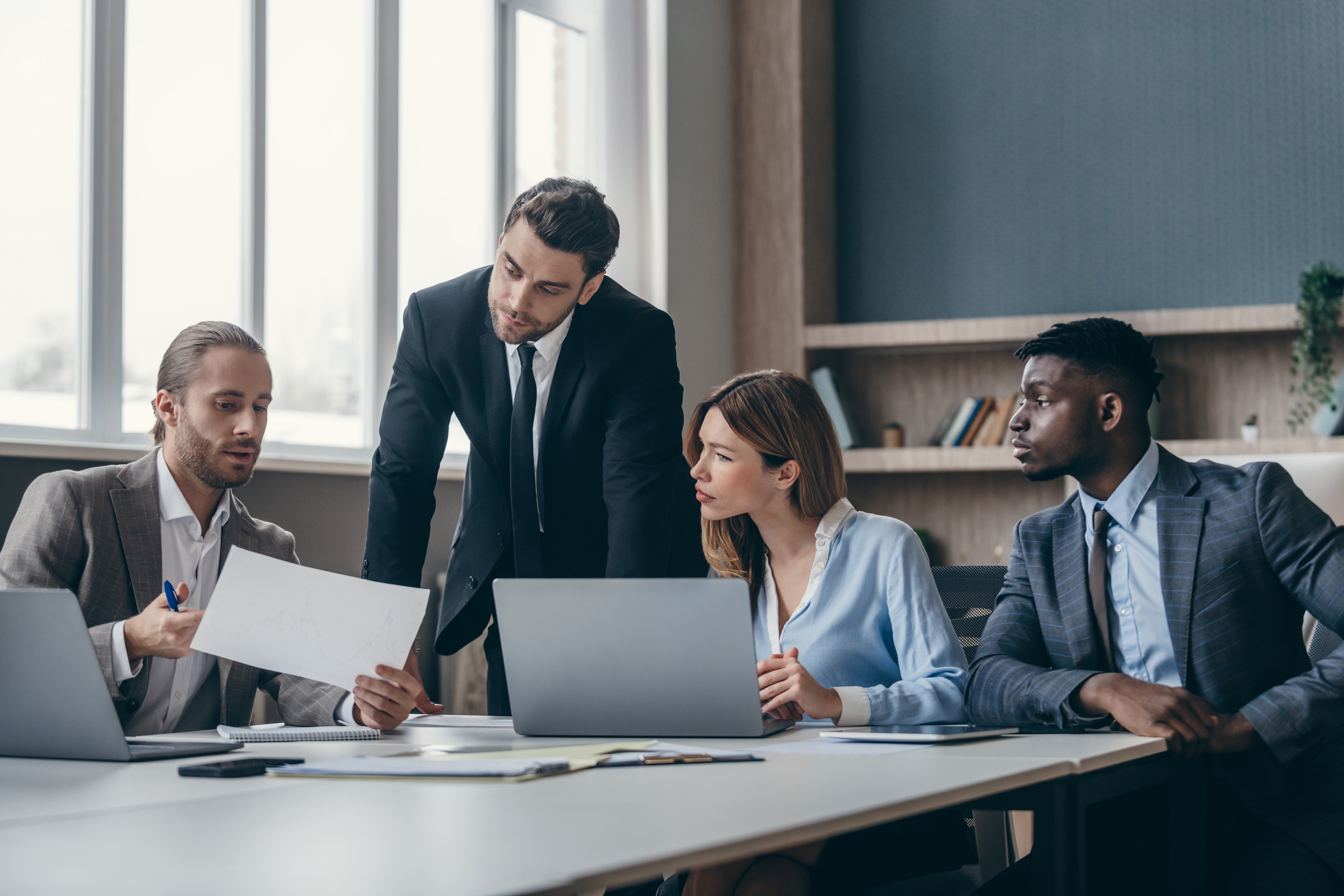 Confident business team discussing strategy while having group meeting at the office desk